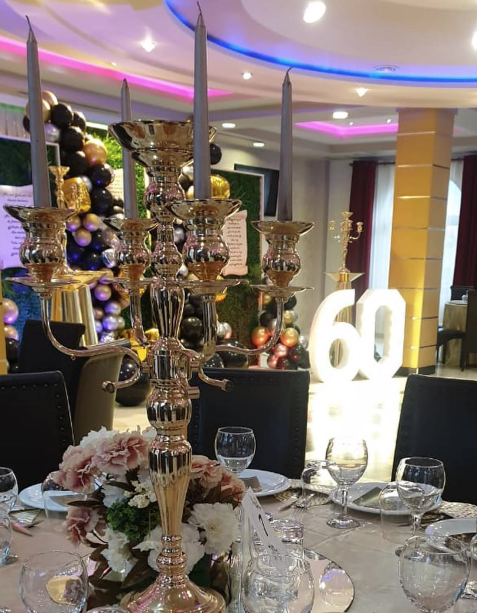 Sixtieth celebration setup with candelabra and balloon decor.