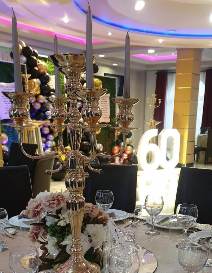 Sixtieth celebration setup with candelabra and balloon decor.